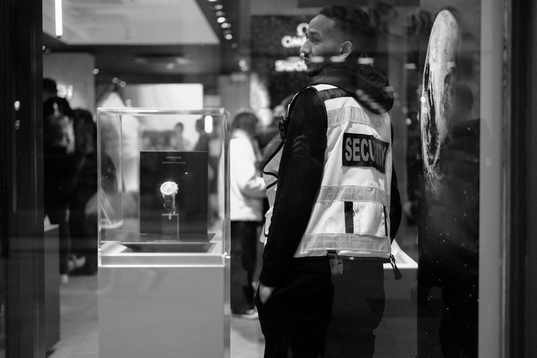Security guard in a luxury Dublin store at night, showcasing urban security and retail ambiance.