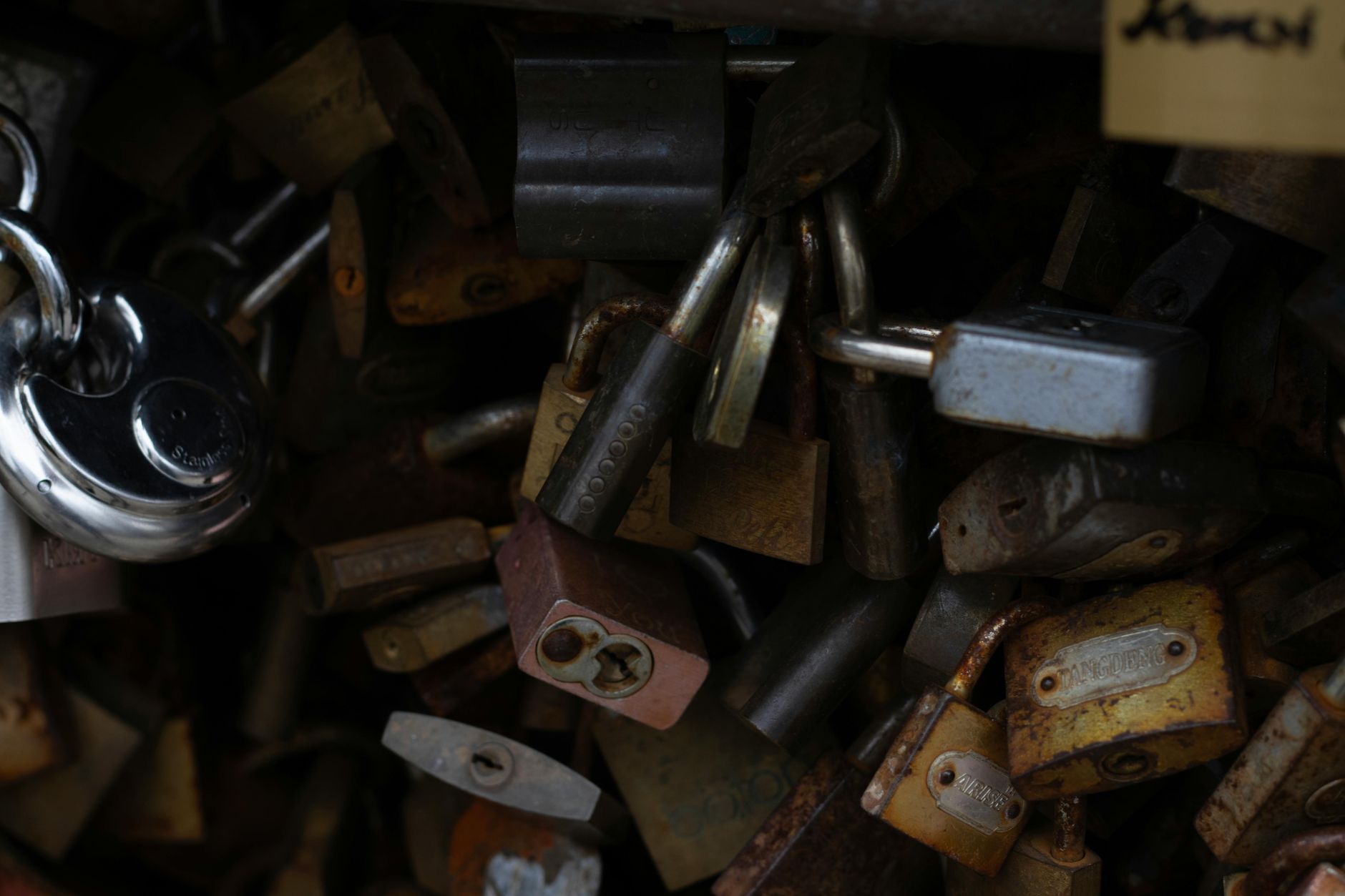 Image showing a pile of rustic and shiny padlocks, symbolizing security.