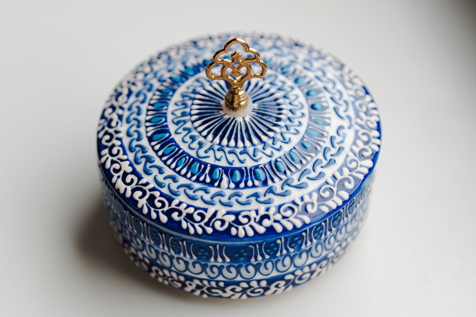 Detailed blue and white ceramic container with intricate patterns and a decorative lid.