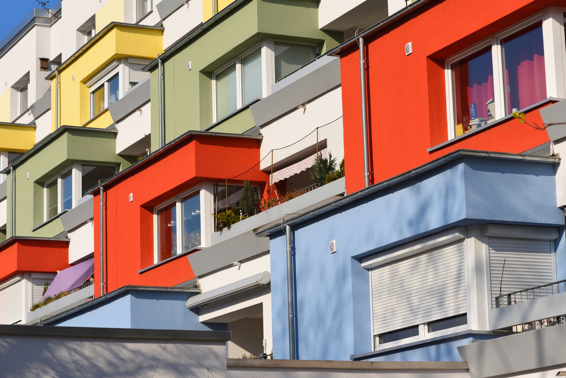 Multi-colored apartment facades in Hannover, Germany, showcasing modern urban architecture.