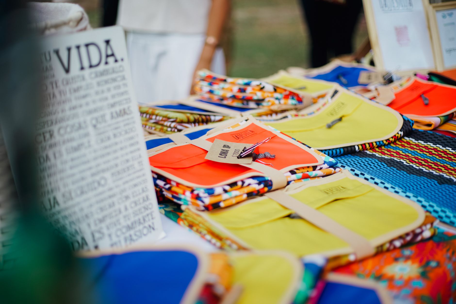 Vibrant handmade crafts on display at an outdoor market, featuring colorful designs and patterns.