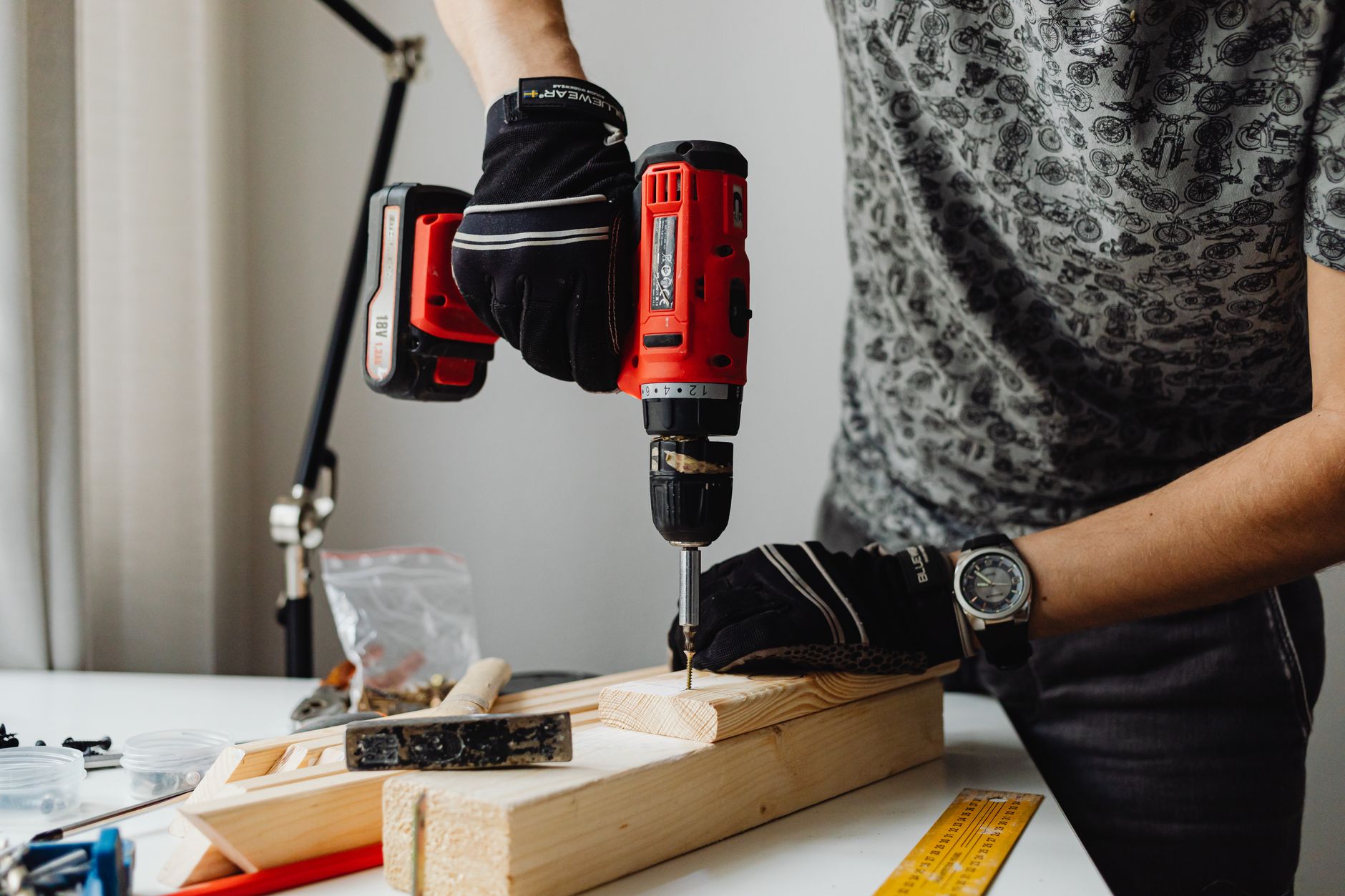 A skilled craftsman working on a wooden piece using a power drill, showcasing precision and expertise.