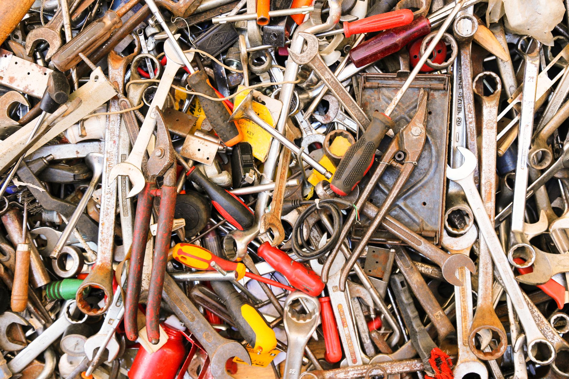 A vibrant assortment of various hand tools arranged in a pile. Ideal for construction themes.