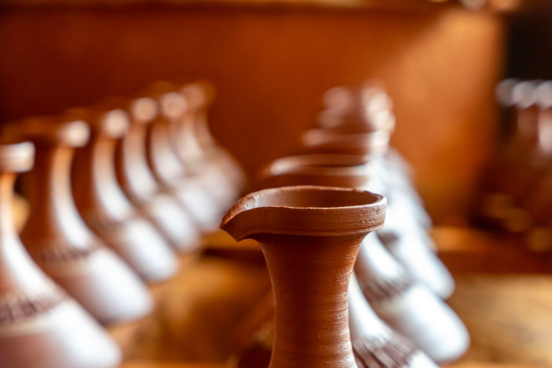A row of handcrafted clay vases highlighting traditional pottery craftsmanship.