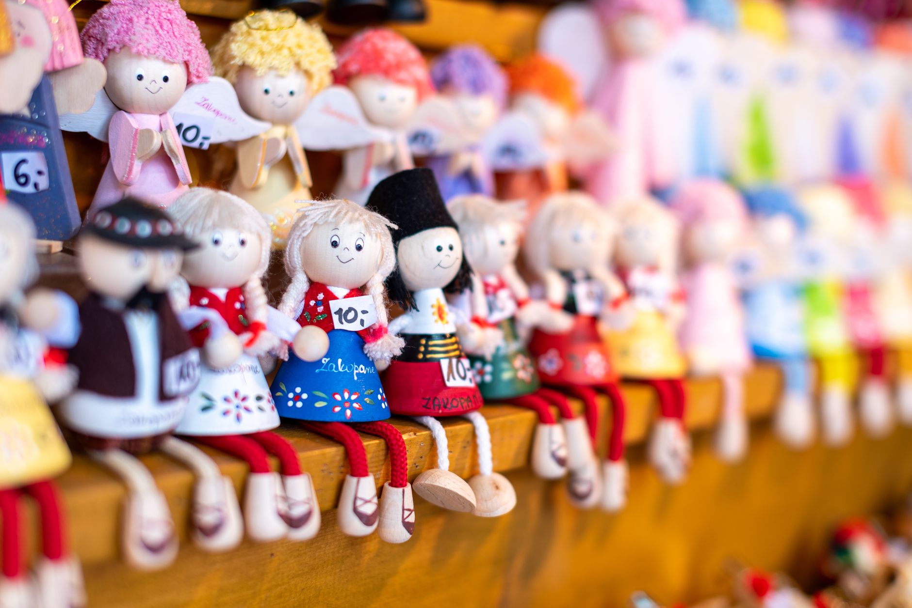 Charming hand-painted dolls displayed in a Zakopane gift shop, showcasing local Polish craftsmanship.
