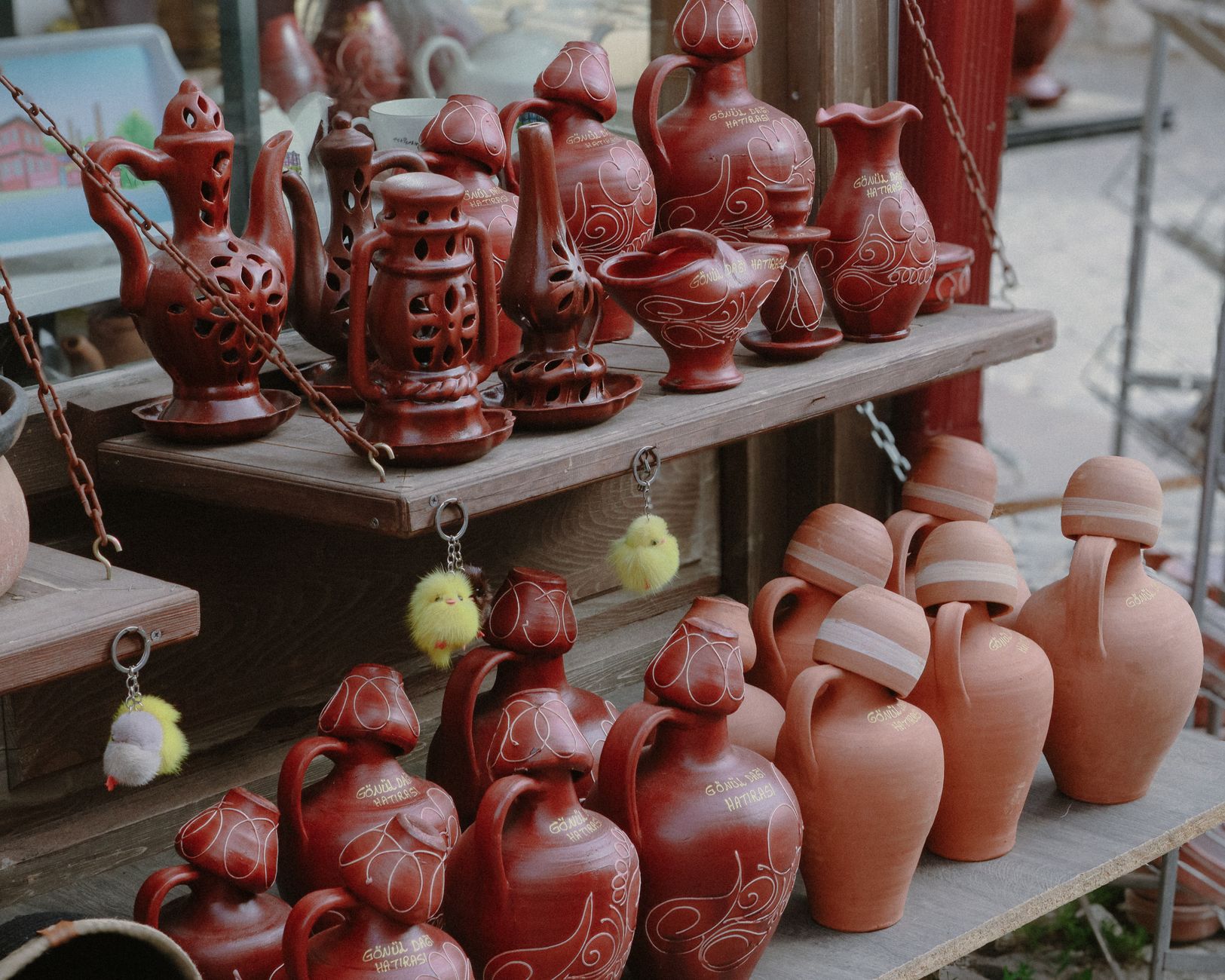 Traditional clay pots and pitchers on display at an outdoor artisan market, perfect for home decor lovers.