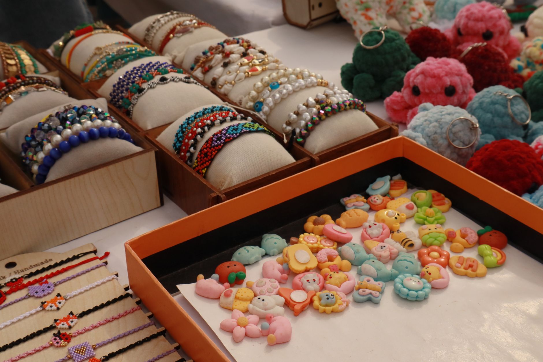 Vibrant display of beaded bracelets and handmade crafts at a market stall.