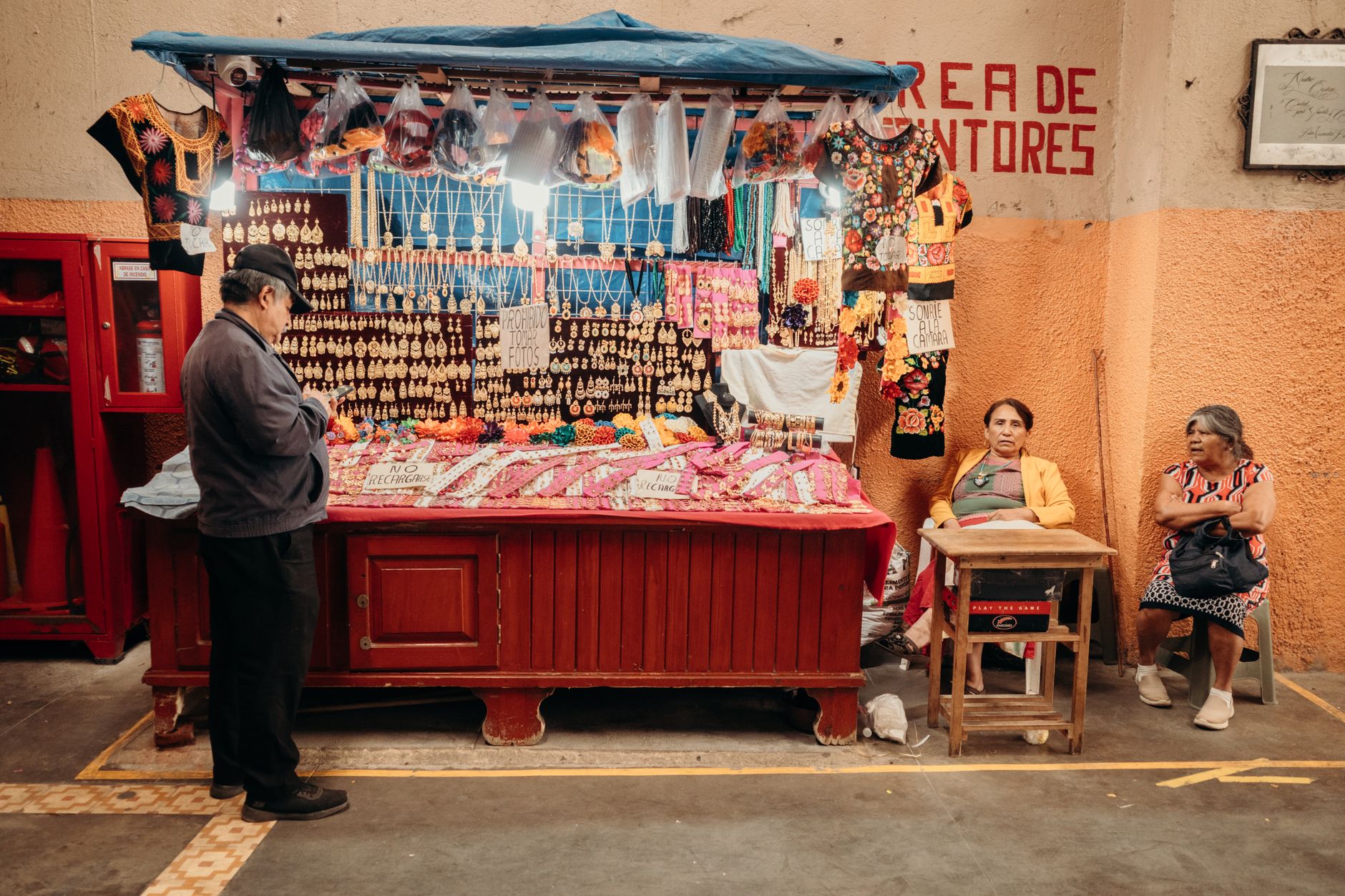 A vibrant market stall showcasing traditional crafts and clothing in an artisan marketplace.